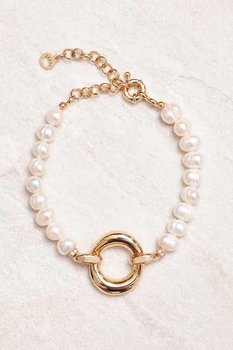  18K gold-plated clasp with small crystal studs. Adorned with baroque pearls. Handmade in Brazil. 