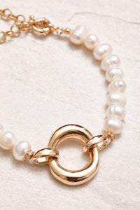 18K gold-plated clasp with small crystal studs. Adorned with baroque pearls. Handmade jewelry in Brazil. 
